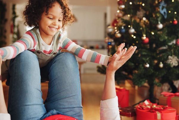 Christmas, airplane and smile with child and parent for festive magic, Noel cheer and xmas celebration. Support, winter holiday and love with people at family home for present, vacation and playful.