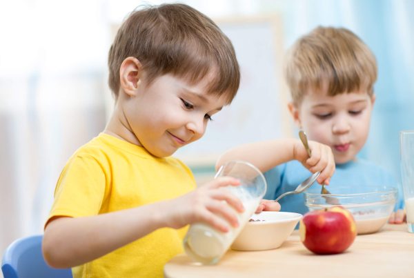 Children eating healthy food at home or kindergarten