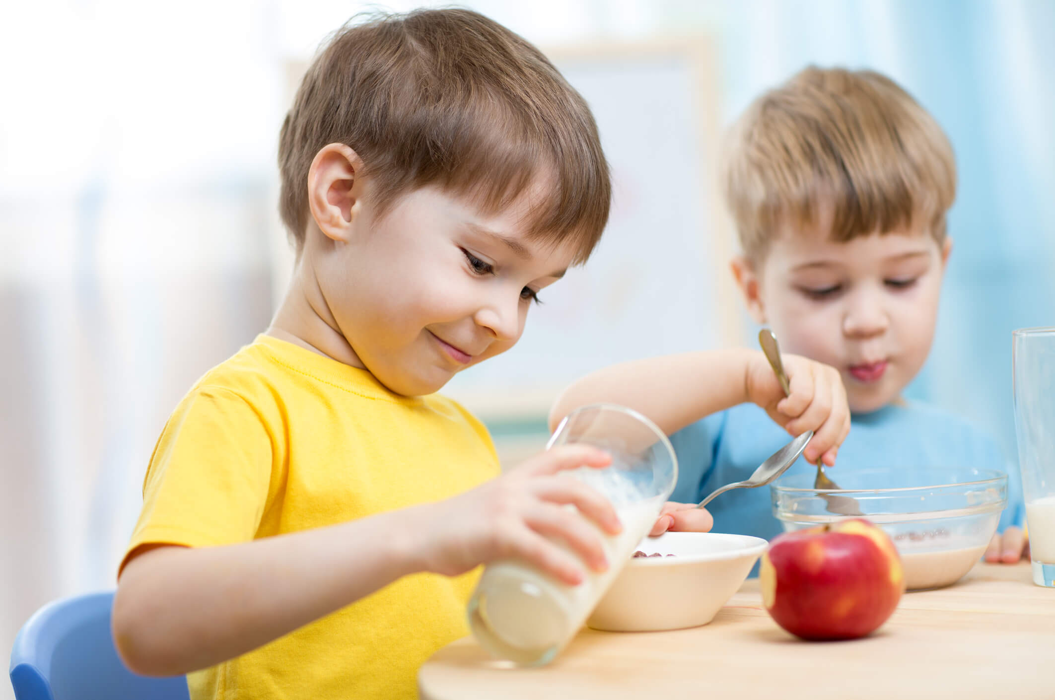 Children eating healthy food at home or kindergarten